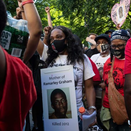 Constance Malcolm, wearing a placard with a photo her son Ramarley Graham, during a demonstration in New York.