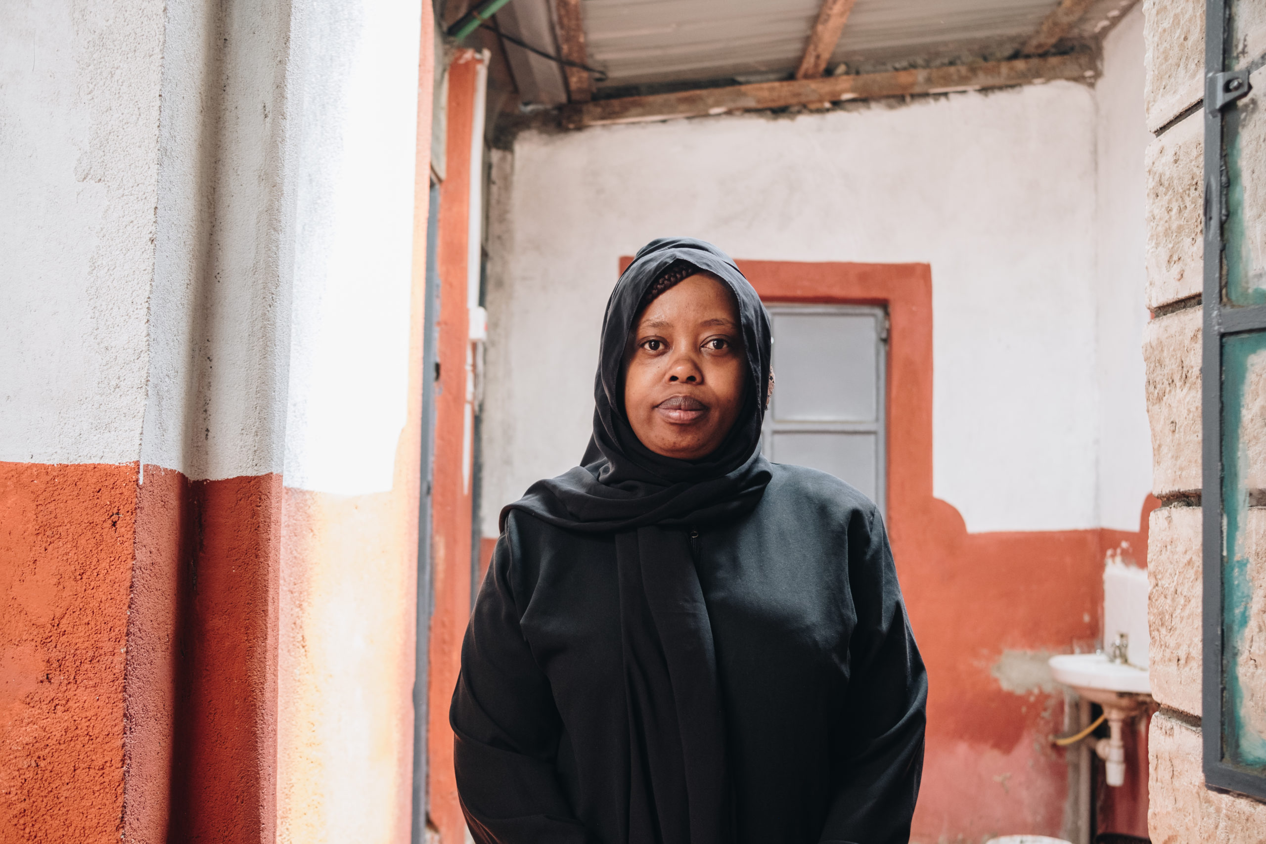 Portrait of a woman standing inside of a residence