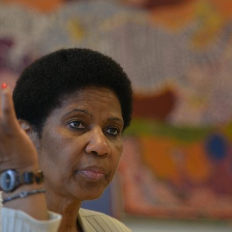 Photograph of a woman with her hand raised