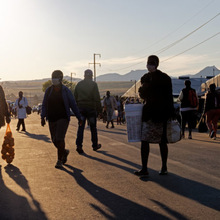 A group of people walk along on a street