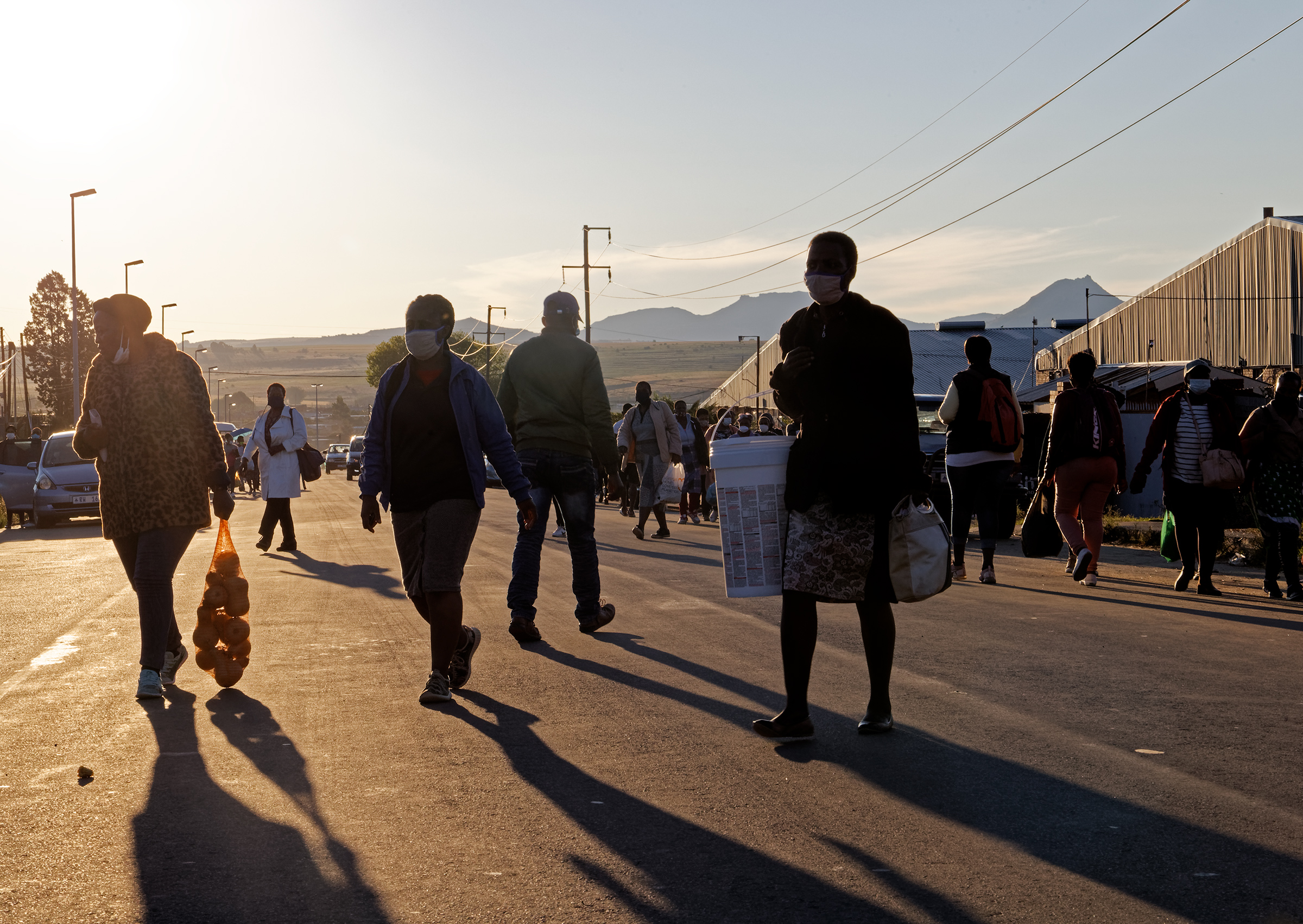 A group of people walk along on a street