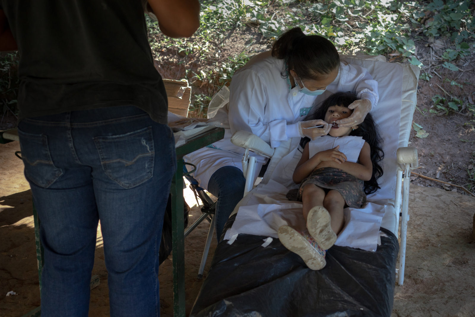A photo of a dentist examining a child's mouth