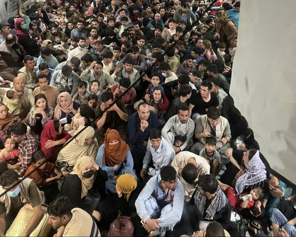 A photo of refugees crowded inside a military aircraft