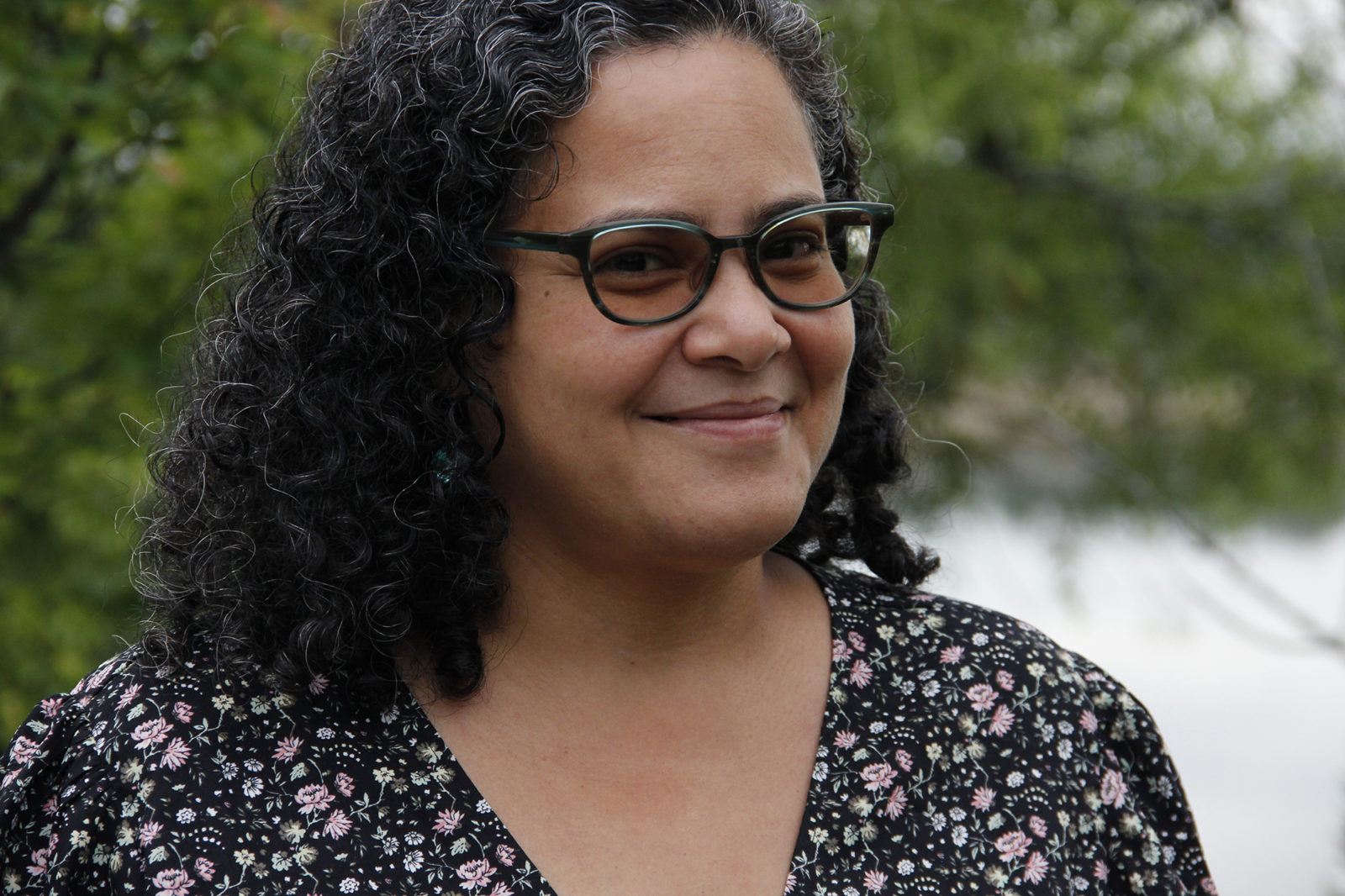 A close up portrait photo of a woman wearing glasses