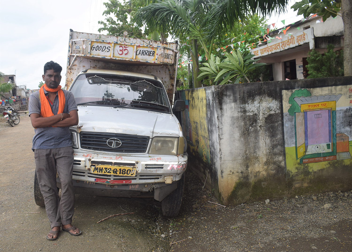 A photo of a man standing by a truck