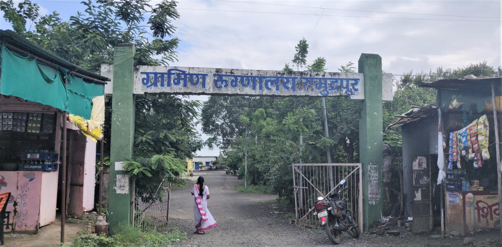 The photo of a woman walking through a hospital entrance