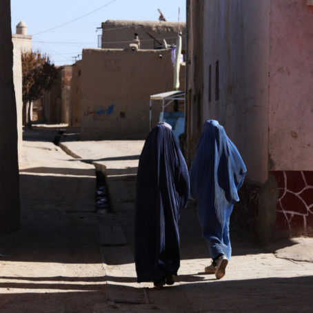 Two women walking on a street
