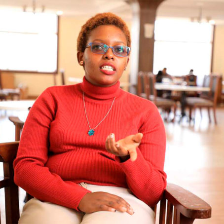 Photo of a woman seated in a chair speaking