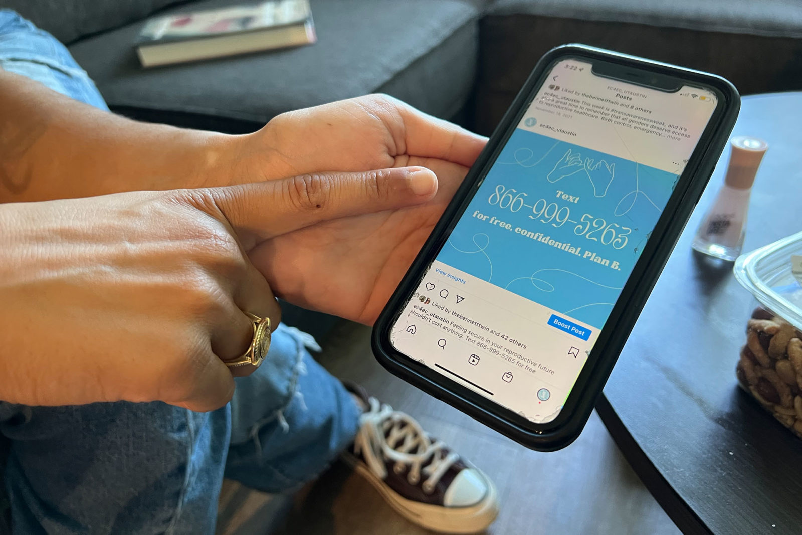 A photo of a person holding a cell phone with a phone number displayed