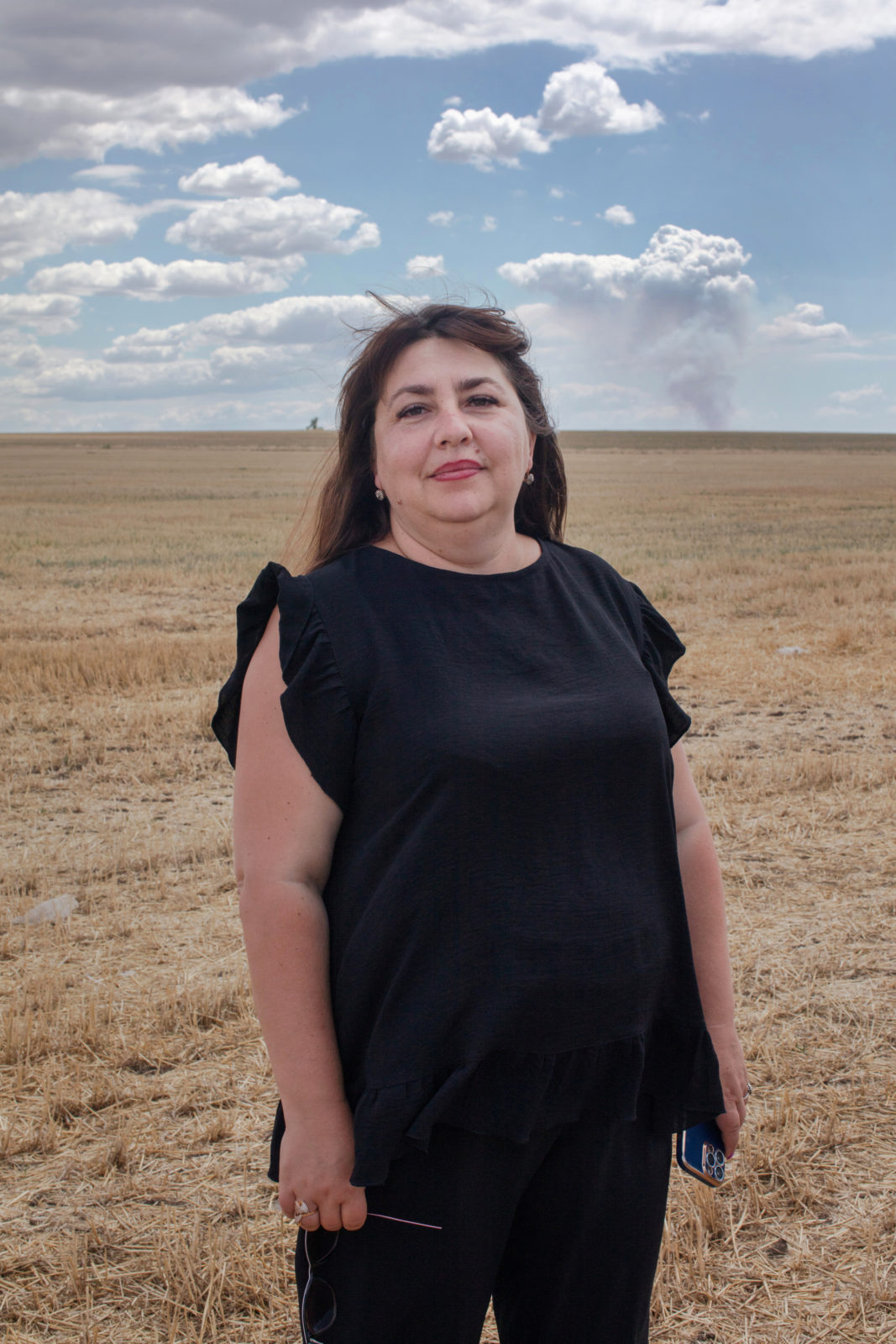 A woman stands in a field