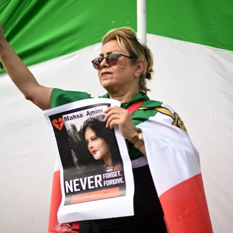 A woman protester holds a photograph of Kurdish woman Mahsa Amini during a protest on October 1, 2022 in Trafalgar Square in London.