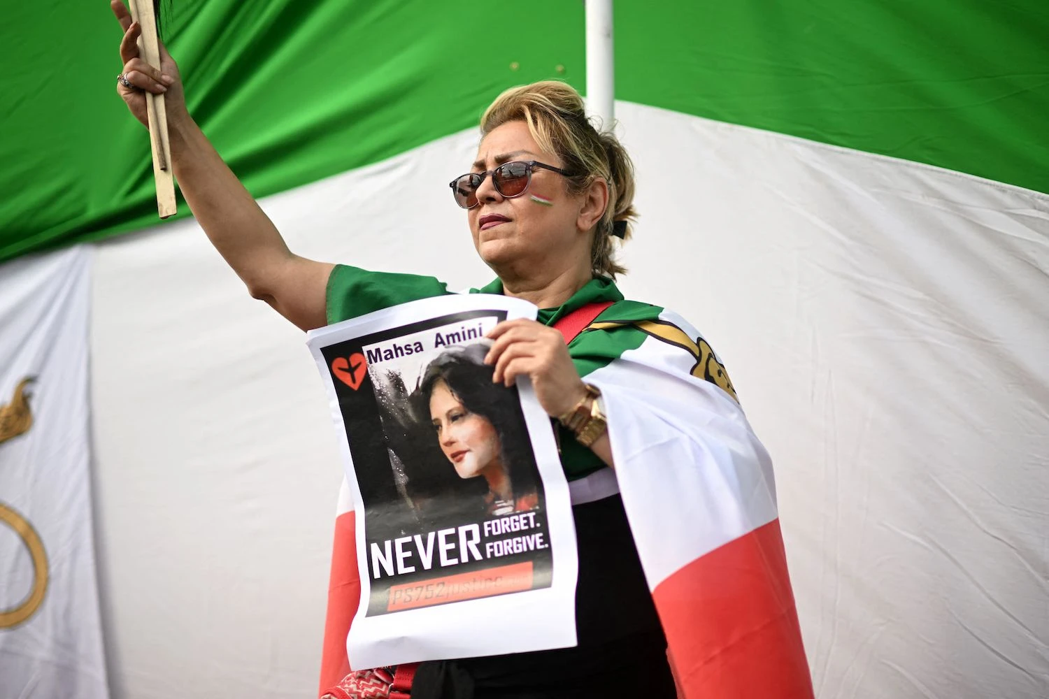 A woman protester holds a photograph of Kurdish woman Mahsa Amini during a protest on October 1, 2022 in Trafalgar Square in London.