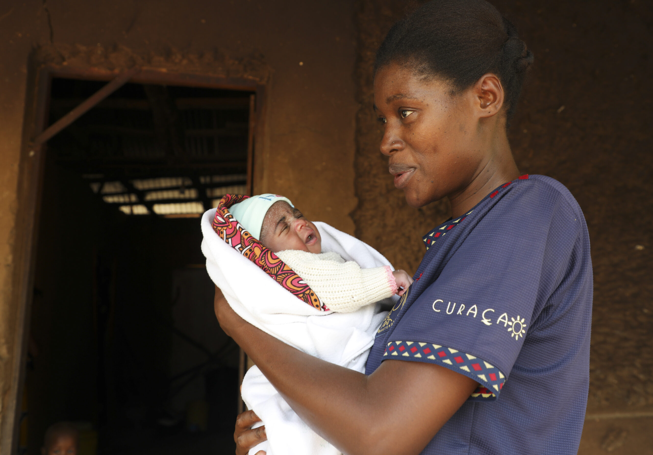 Woman holding her new born baby.