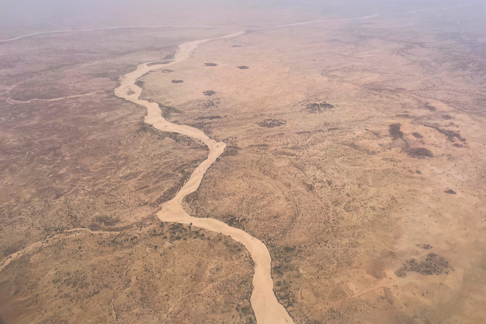 An aerial view of the arid landscape of eastern Chad in April 2024. (Photo by Zoë Flood/Foreign Policy)