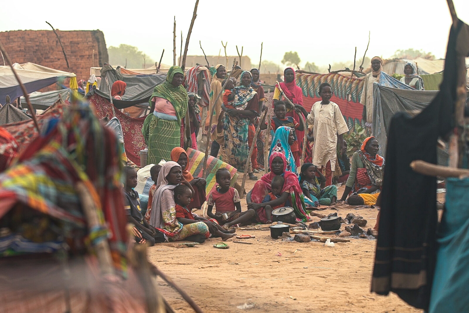 Newly arrived refugees — many of them women and children — gather just across the border in eastern Chad in April 2024, after fleeing attacks in Darfur. (Photo by Zoë Flood/Foreign Policy)