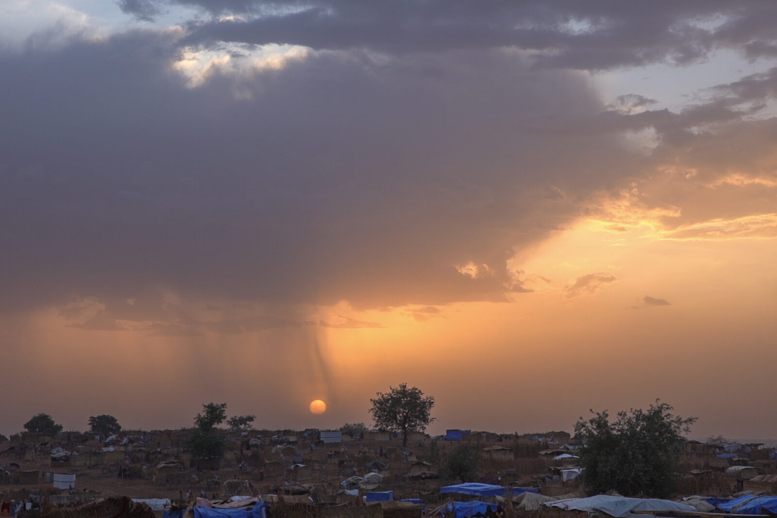 The sun sets over the Adré transit camp in April 2024. (Photo by Zoë Flood/Foreign Policy)