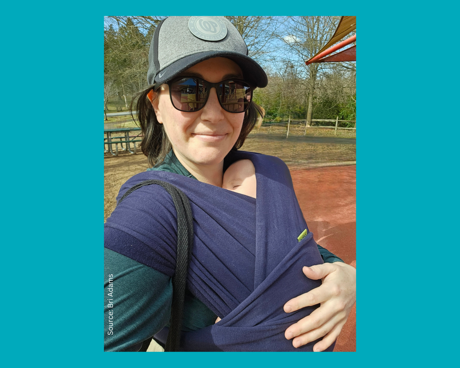 Woman holds baby in park