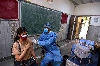 NEW DELHI, INDIA - MAY 3: A health worker administers a shot of Covid-19 vaccine,  Today Start the age group of 18 to 44 vaccination Drive at a Govt School Sarvodaya Kanya Vidyalaya, West Vinod Nagar, Patpatganj   on May 3, 2021 in New Delhi, India.  Kicking off the COVID-19 vaccination drive in Delhi, Deputy Chief Minister Manish Sisodia visited Sarvodaya Kanya Vidyalaya, West Vinod Nagar, where 5 sites have been set up for citizens to get COVID-19 vaccines starting today for individuals aged 18-45 years. Deputy Chief Minister Shri Manish Sisodia said, Delhi Government has received 4.5 lakh vaccination doses until now, on the basis of which 301 vaccination centres have been made in 76 schools across Delhi, vaccinating 45,100 citizens.    ( Photo by Sonu Mehta/Hindustan Times via Getty Images)